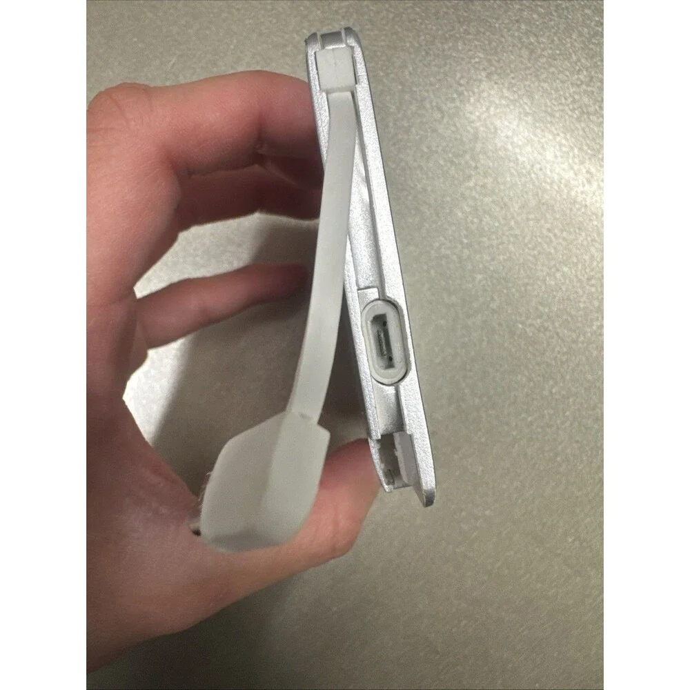 Ultra Slim portable charger silver with looks like Micro-USB cord see photos